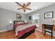 Cozy bedroom with a ceiling fan and natural light coming through the windows at 6511 Georgia Ave, Bradenton, FL 34207