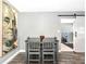 Dining area with a modern light fixture, neutral walls, wood-look floors, and sliding barn door to another room at 6511 Georgia Ave, Bradenton, FL 34207