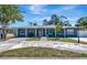 Charming single-story home with a well-manicured lawn and inviting curb appeal, front-facing view on a sunny day at 6511 Georgia Ave, Bradenton, FL 34207