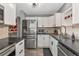 Modern kitchen showcasing stainless steel appliances, white cabinets, and dark countertops at 6511 Georgia Ave, Bradenton, FL 34207