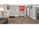 Inviting living area with wood-look floors, a console table, and neutral paint, creating a modern aesthetic at 6511 Georgia Ave, Bradenton, FL 34207