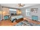 This bedroom has a king-sized bed, barn door decor, wood floors and a neutral palette at 6511 Georgia Ave, Bradenton, FL 34207