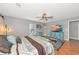 This bedroom has a king-sized bed, decor, wood floors and a neutral palette at 6511 Georgia Ave, Bradenton, FL 34207