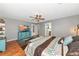 This bedroom has a king-sized bed, decor, wood floors and a neutral palette at 6511 Georgia Ave, Bradenton, FL 34207