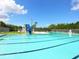 Community pool with a slide, seating, and a large fenced-in area at 6511 Georgia Ave, Bradenton, FL 34207