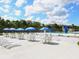 Community pool with tables, umbrellas, seating, and a slide at 6511 Georgia Ave, Bradenton, FL 34207