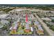 Aerial view of complex featuring a community pool, surrounded by lush landscaping, and ample parking in a well maintained community at 6800 20Th N Ave # 307, St Petersburg, FL 33710