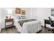 Cozy bedroom featuring coastal-themed decor, a comfortable bed, and hardwood flooring at 6800 20Th N Ave # 307, St Petersburg, FL 33710