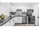 Modern kitchen features white cabinets, stainless appliances, dark granite countertops and stylish tile backsplash and ample counter space at 6800 20Th N Ave # 307, St Petersburg, FL 33710