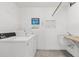 Well-maintained laundry room with modern washing machines, sink, and informational signage at 6800 20Th N Ave # 307, St Petersburg, FL 33710