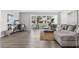 Bright and inviting living area featuring stylish furniture, wood-look floors, neutral paint, and a large window with lots of natural light at 6800 20Th N Ave # 307, St Petersburg, FL 33710