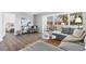 Comfortable living area featuring stylish furniture, wood-look floors, neutral paint, and access to a bedroom and a bright sunroom at 6800 20Th N Ave # 307, St Petersburg, FL 33710