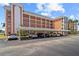 Exterior view of condo complex featuring a covered parking area and multiple balconies at 6800 20Th N Ave # 307, St Petersburg, FL 33710