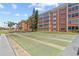 Shuffleboard courts with the condo complex in the background and mature palm trees around the lawn at 6800 20Th N Ave # 307, St Petersburg, FL 33710