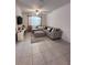 Comfortable living room featuring a sectional, window for natural light, and a ceiling fan at 6942 Ripple Pond Loop, Zephyrhills, FL 33541