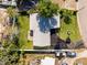 Aerial view showcasing a well-maintained property with a lush green lawn, mature trees, and convenient driveway at 722 61St S Ave, St Petersburg, FL 33705