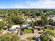 Aerial view showcasing a residential neighborhood surrounded by mature trees and glimpses of ocean views at 722 61St S Ave, St Petersburg, FL 33705