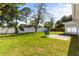 Expansive backyard features a lush lawn, mature trees, a patio, and fencing in the rear at 722 61St S Ave, St Petersburg, FL 33705
