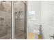 Contemporary bathroom showcasing a tiled shower, built-in shelving, and a toilet with modern fixtures at 722 61St S Ave, St Petersburg, FL 33705