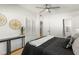 Modern bedroom with a ceiling fan, a contemporary accent table, and a door to a bathroom nearby at 722 61St S Ave, St Petersburg, FL 33705