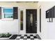Elegant front entrance showcasing a decorative door, black and white tiled foyer, and stylish accents at 722 61St S Ave, St Petersburg, FL 33705