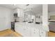 Stylish kitchen island featuring stainless steel appliances and white countertops and cabinetry at 722 61St S Ave, St Petersburg, FL 33705
