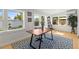Sunlit office space with a large modern desk, light wood floors, and windows overlooking a well-maintained backyard at 722 61St S Ave, St Petersburg, FL 33705