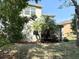 Spacious backyard featuring a screen enclosed patio and lush tropical landscaping at 7704 Tuscany Woods Dr, Tampa, FL 33647