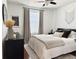 Stylish bedroom featuring modern furniture, window with blinds and hardwood flooring at 7704 Tuscany Woods Dr, Tampa, FL 33647