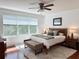 Bedroom with a neutral color scheme, ceiling fan and window at 7704 Tuscany Woods Dr, Tampa, FL 33647