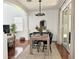 Dining room featuring hardwood floors, modern lighting, and access to the outdoors through sliding glass doors at 7704 Tuscany Woods Dr, Tampa, FL 33647