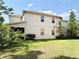 View of the back of the home featuring a manicured lawn and partial fencing for privacy at 7704 Tuscany Woods Dr, Tampa, FL 33647