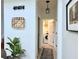 Hallway leading to the laundry room featuring a modern light fixture and decorative wall art at 7704 Tuscany Woods Dr, Tampa, FL 33647