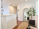 Upstairs hallway with wood floors, decorative mirror, and bench seating at 7704 Tuscany Woods Dr, Tampa, FL 33647