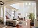 Spacious living room with high ceilings, modern furnishings, and abundant natural light from large windows at 7704 Tuscany Woods Dr, Tampa, FL 33647