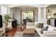 Bright living room and dining area featuring an open layout, wood floors, and modern decor at 7704 Tuscany Woods Dr, Tampa, FL 33647