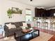 Cozy living room with a kitchen view, featuring hardwood floors and natural lighting at 7704 Tuscany Woods Dr, Tampa, FL 33647