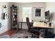 Modern home office featuring bamboo desks, comfortable chair, and bookcase at 7704 Tuscany Woods Dr, Tampa, FL 33647