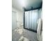 Bright bathroom with a walk-in shower, marble floors, and a white door at 8050 Roxburgh Ct, Weeki Wachee, FL 34613