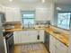 Well-lit kitchen with modern stainless appliances and butcher block countertops at 8050 Roxburgh Ct, Weeki Wachee, FL 34613