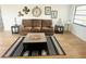 Cozy living room features a comfortable couch, wood-look floors, and coastal-themed decor at 8050 Roxburgh Ct, Weeki Wachee, FL 34613