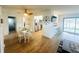 Open-concept living room with white walls, wood-look tile flooring, and eat-in kitchen at 8050 Roxburgh Ct, Weeki Wachee, FL 34613