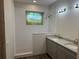 Modern bathroom featuring tiled shower, dual sinks, and granite countertops at 8149 Cashew, Webster, FL 33597