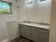 Bright bathroom featuring dual sinks with granite countertops and tiled walk-in shower at 8149 Cashew, Webster, FL 33597