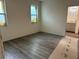 Unfinished bedroom with two windows and durable gray vinyl plank flooring at 8149 Cashew, Webster, FL 33597