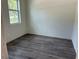 Bedroom with new flooring and a window providing natural light at 8149 Cashew, Webster, FL 33597