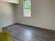 Light-filled bedroom with wood-look flooring and a large window at 8149 Cashew, Webster, FL 33597