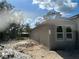 Side exterior view of home with recently applied stucco, new windows, and landscaping potential at 8149 Cashew, Webster, FL 33597