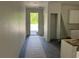 Entry hallway showcases new construction with neutral paint and dark wood-look flooring at 8149 Cashew, Webster, FL 33597
