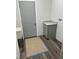 Functional laundry room features a utility sink, gray vanity, and space-saving layout at 8149 Cashew, Webster, FL 33597